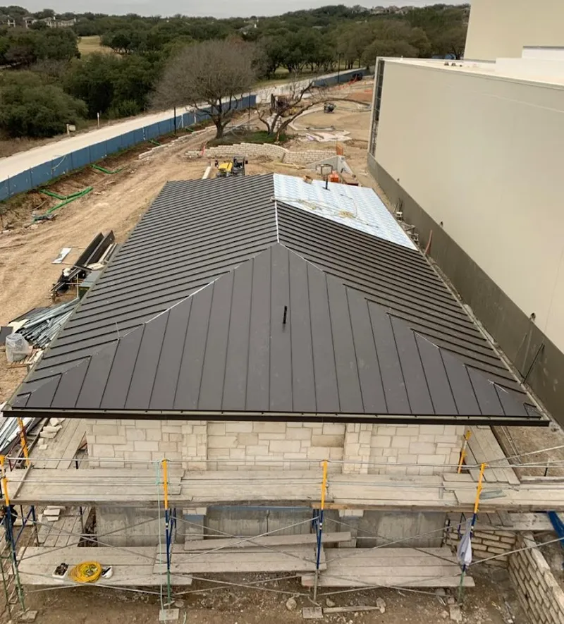 Metal roof new construction with scaffolding in Holly